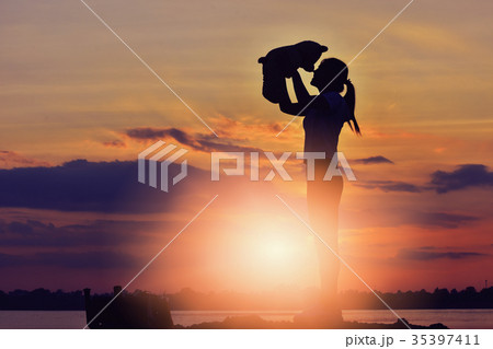 The girl is playing with a teddy bear. The girl is playing with a teddy bear. 35397411