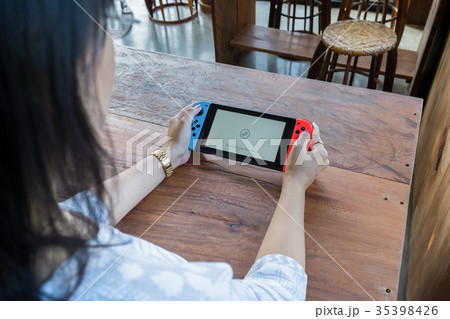 woman hands holding game portable woman hands holding game portable 35398426