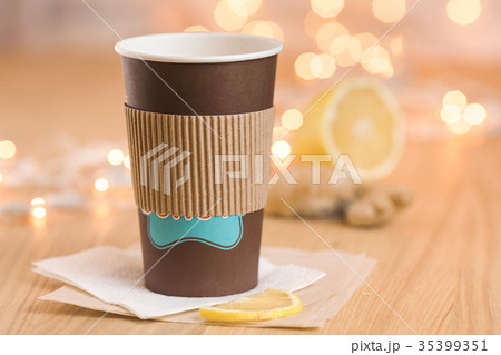 Tea with lemon and ginger in a paper cup 35399351