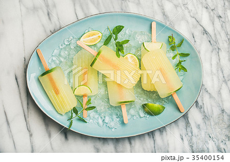 Summer lemonade popsicles with lime, mint leaves 35400154