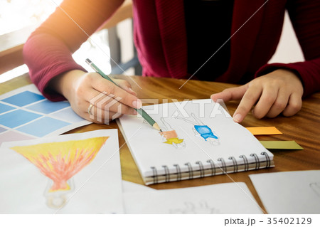 young women working as fashion designer drawing sketches for clo 35402129