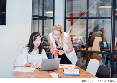 Group of business people meeting in a meeting room, sharing thei 35403505