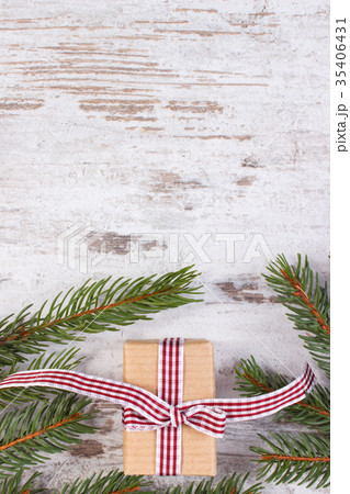 Wrapped gift and spruce branches for Christmas Wrapped gift and spruce branches for Christmas 35406431