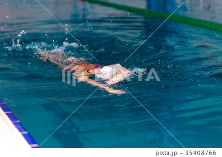 woman swimming with swimming hat in swimming pool woman swimming with swimming hat in swimming pool 35408766