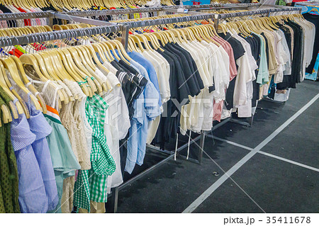 Fashionable clothes in a boutique store 35411678