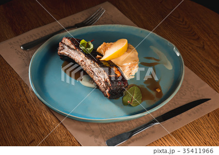 grilled pork ribs on dark plate 35411966