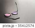 Old black glasses with broken legs. 35412574