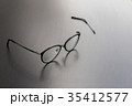 Old black glasses with broken legs. 35412577