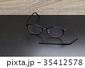 Old black glasses with broken legs. 35412578