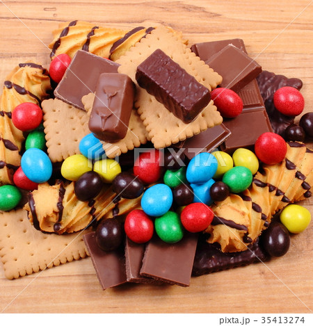 A lot of sweets on wooden surface A lot of sweets on wooden surface 35413274