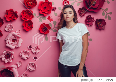 Sexy woman in a white t-shirt on a pink background Sexy woman in a white t-shirt on a pink background 35413959