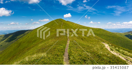 footpath through grassy peak of mountain ridge footpath through grassy peak of mountain ridge 35415087