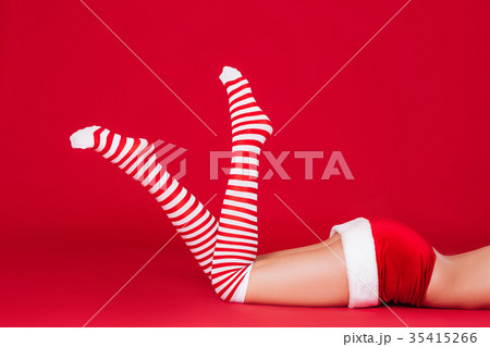 woman legs in striped Christmas stockings  35415266