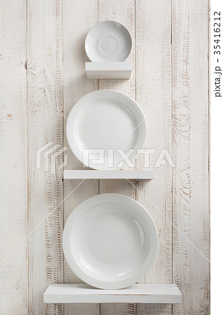 plate at kitchen shelf on wooden background 35416212