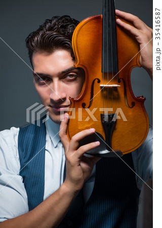 Young musician man practicing playing violin at 35416587