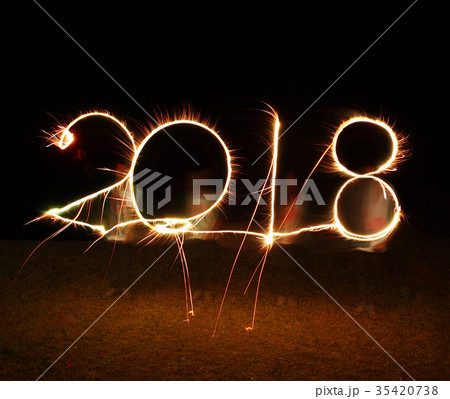 boy write 2018 happy new year firework sparkle boy write 2018 happy new year firework sparkle 35420738