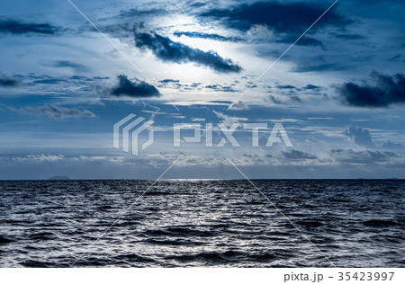 Blue dark dramatic sky with shining ocean Blue dark dramatic sky with shining ocean 35423997