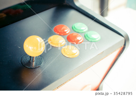 yellow joystick of an old arcade video game  35428795
