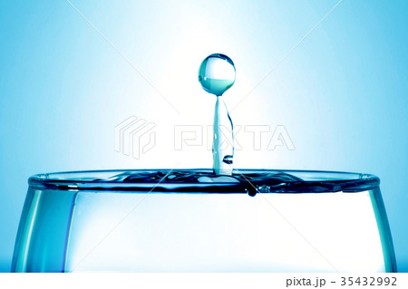 Water drop into a glass closeup, abstract blue 35432992