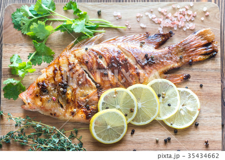 Grilled Tilapia with herbs on the wooden board Grilled Tilapia with herbs on the wooden board 35434662