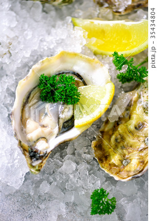 Fresh opened oysters, lemon, herbs, ice on Fresh opened oysters, lemon, herbs, ice on 35434804