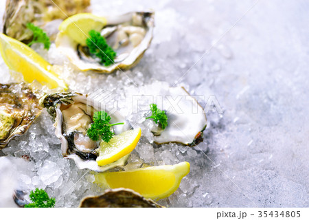 Fresh opened oysters, lemon, herbs, ice on Fresh opened oysters, lemon, herbs, ice on 35434805