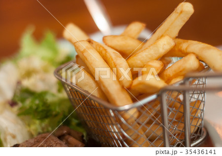 french fries in little metallic basket  35436141