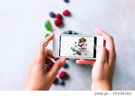Girl is taking photos of breakfast, chia pudding 35436162