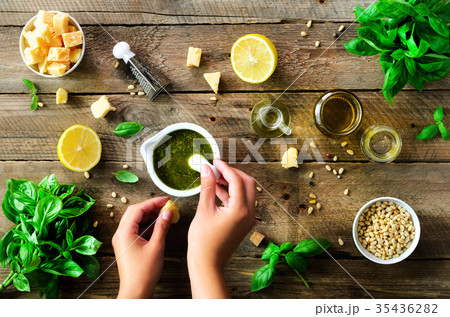 Woman hands making italian pesto in bowl 35436282