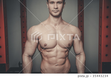 Handsome model young man posing in gym 35443234