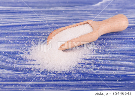 White sugar on wooden spoon  35446642