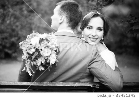 Newlyweds groom and bride walking in autumn park Newlyweds groom and bride walking in autumn park 35451245