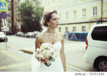 Bride in a white dress at a wedding is beautifully solemn 35451360