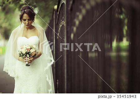 Bride in a white dress at a wedding is beautifully solemn Bride in a white dress at a wedding is beautifully solemn 35451943