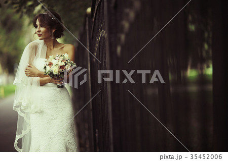 Bride in a white dress at a wedding is beautifully solemn Bride in a white dress at a wedding is beautifully solemn 35452006