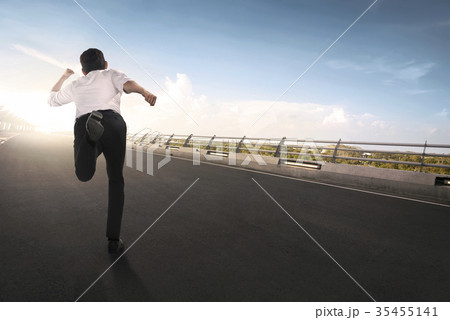Back view of asian businessman running Back view of asian businessman running 35455141