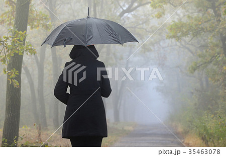 Depressed woman with red umbrella 35463078