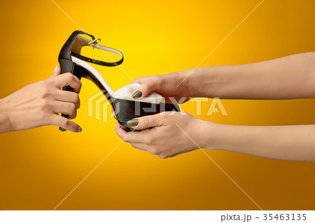 Brown woman shoe with female and male on hands 35463135