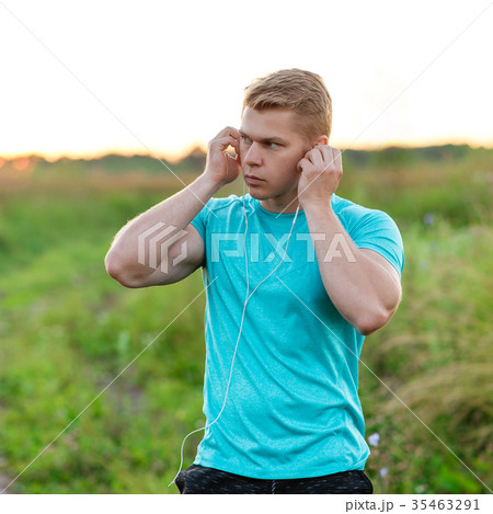 A man atlen stands in the park dresses the 35463291