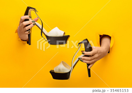 Brown woman shoe on hand isolated Brown woman shoe on hand isolated 35465153