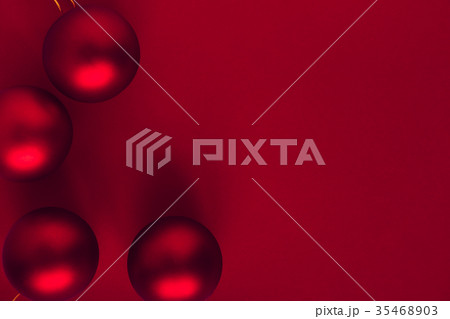 Red Christmas balls on red background Red Christmas balls on red background 35468903