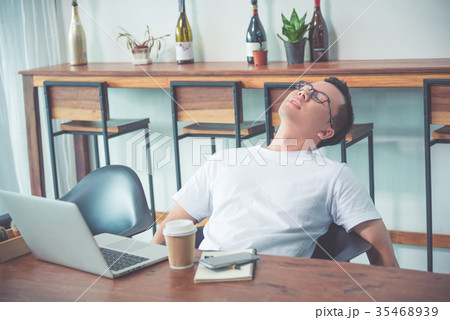 businessman resting on chair after tired from work businessman resting on chair after tired from work 35468939