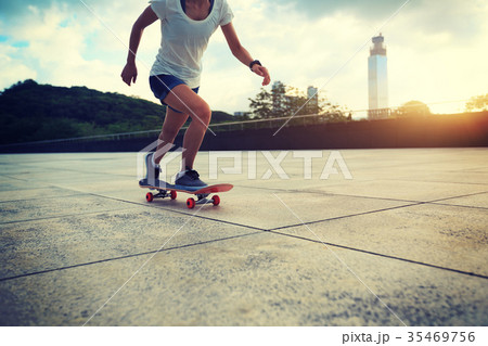 Woman practicing with skateboard at sunrise city Woman practicing with skateboard at sunrise city 35469756