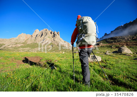 woman with backpack hiking in mountains woman with backpack hiking in mountains 35470826