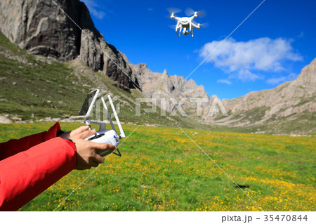 photographer with flying drone outdoors 35470844