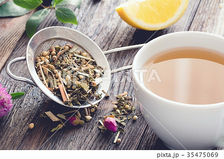 Mix of herbal tea and cup of herbal tea on wood 35475069
