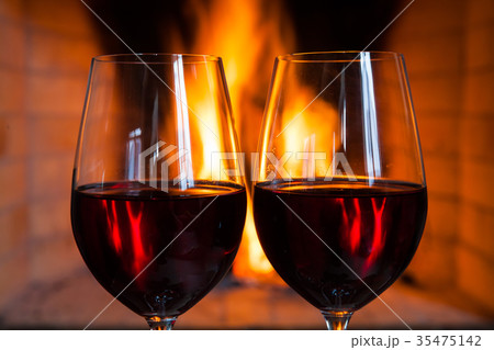Two glasses of red wine on the background of fire 35475142