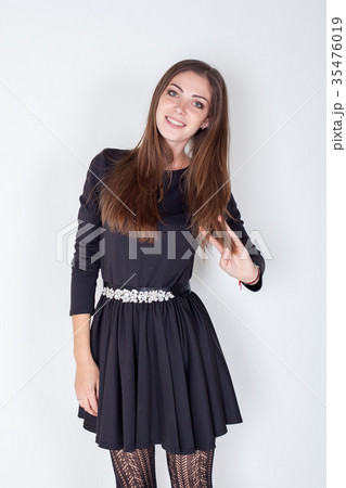 Portrait of a girl in a black dress on a white 35476019