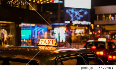 Taxi sign night blur view in nightlife area 35477403