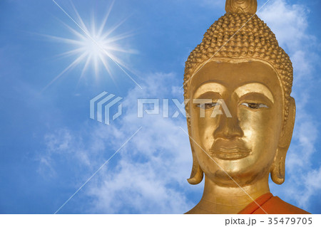 close up face of buddha with blue sky background close up face of buddha with blue sky background 35479705